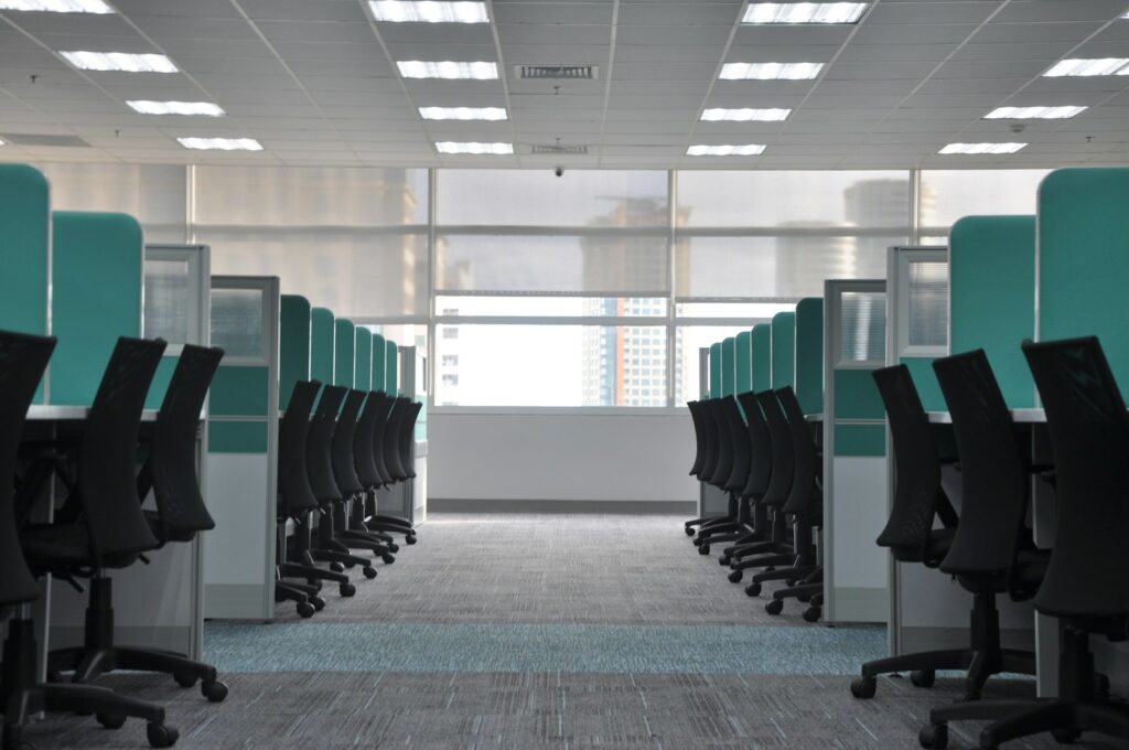 Rows of cubicle workstations with green panels