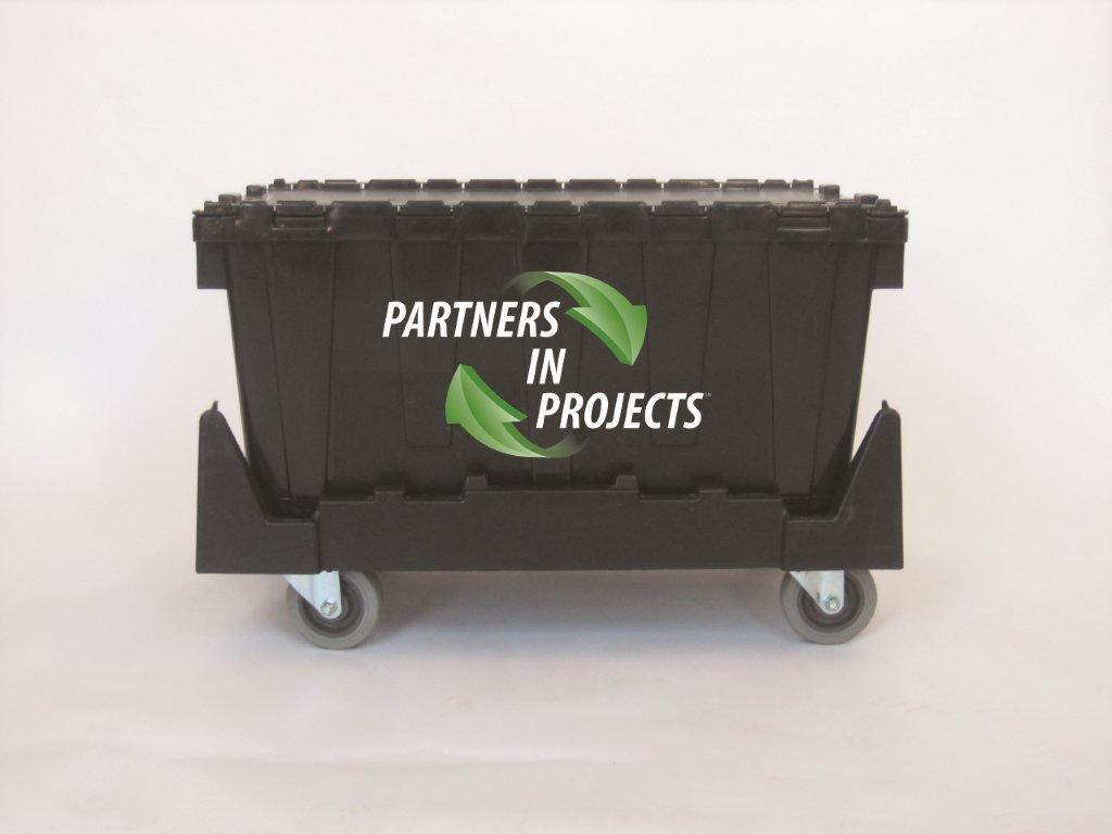 Black reusable moving crate with the Partners in Projects logo on a rolling dolly